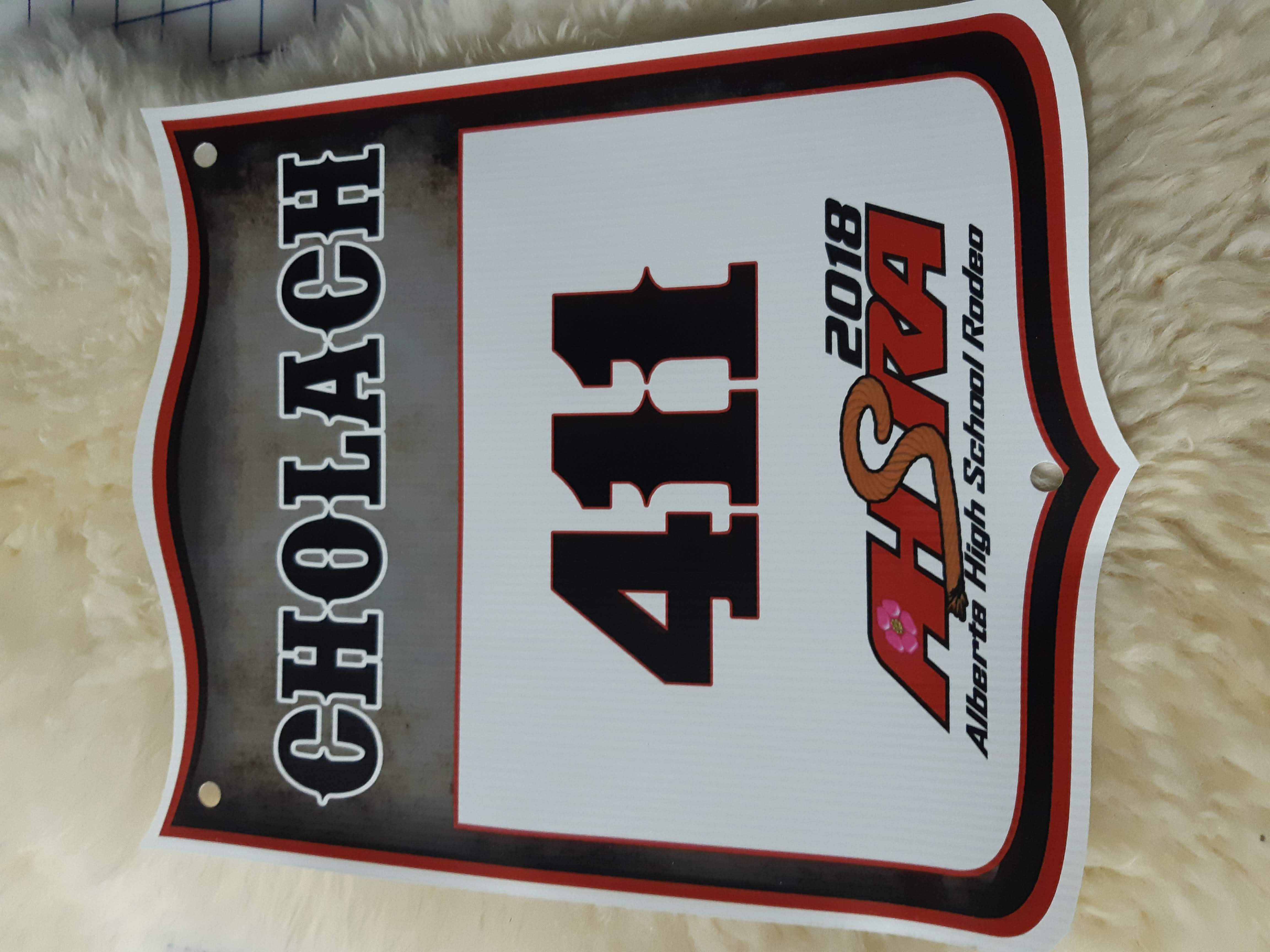 Named rodeo back number with grommet holes